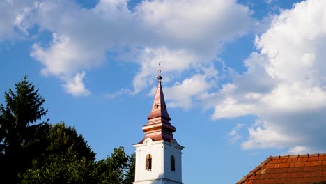 clouds moving over small church steeple, varbo, hungary