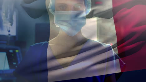 animation of french flag with healthcare worker in background during coronavirus pandemic