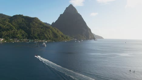 Sunny-day-drone-shot-of-mountain-peaks-and-beach-in-the-Caribbean