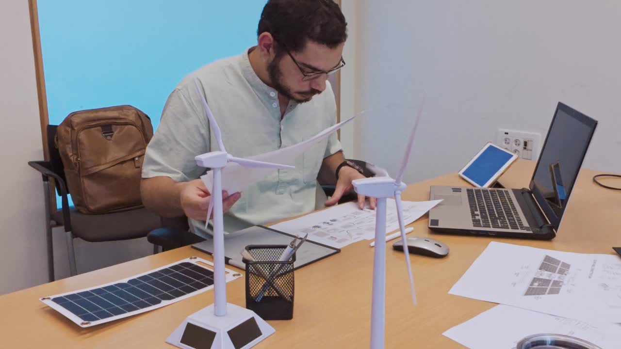 Architect Reviewing Technical Diagrams for a Wind Power Project