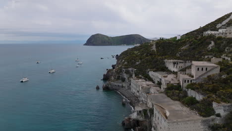 4k aerial tracking past lipari abandoned pomice mine accomodation, italy