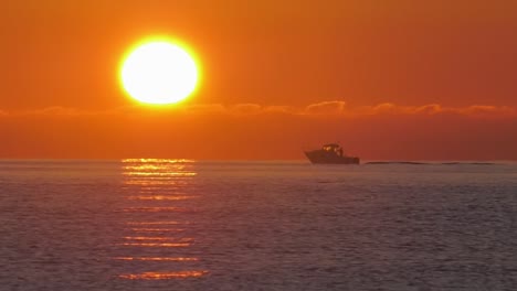 Sport-fishing-boat-at-sunrise-on-calm-ocean