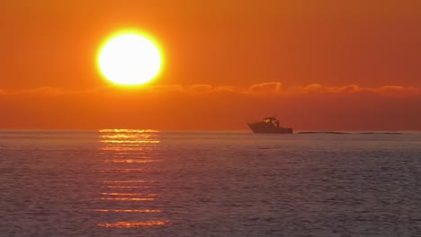 sport fishing boat at sunrise on calm ocean