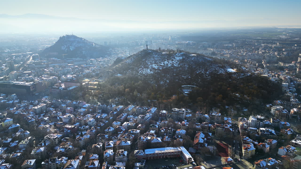 Aerial drone view of Plovdiv city covered in snow. The monument of the Red Army "Alyosha" on Bunarjik Hill. Bulgaria