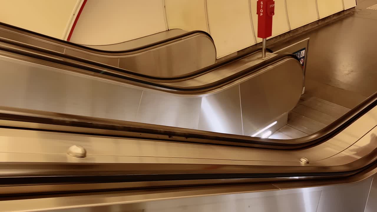 Empty metallic escalators in a clean and bright subway station setting