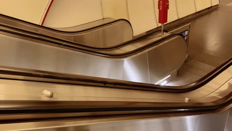 empty metallic escalators in a clean and bright subway station setting