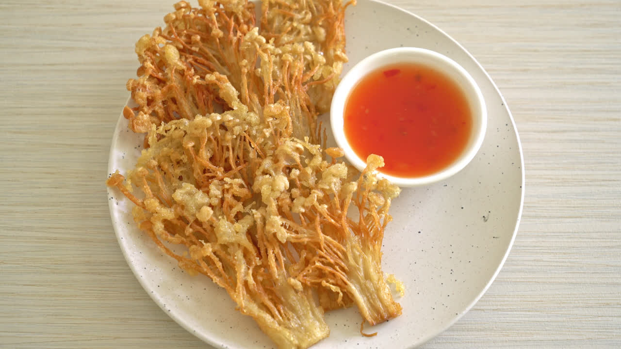 deep fried enoki mushroom or golden needle mushroom with spicy dipping sauce - vegan food style