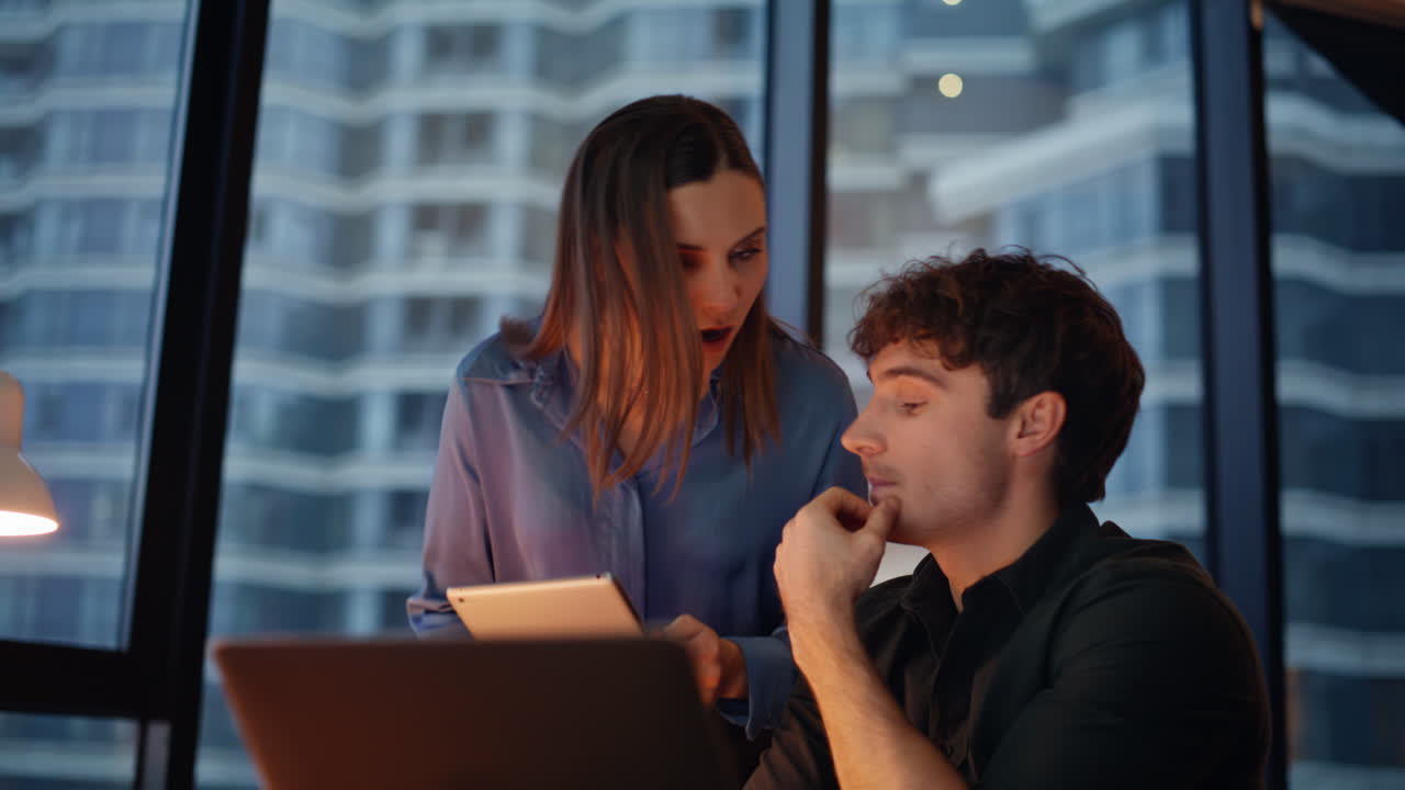 Partners discussing project videocall collaborating in dark office closeup