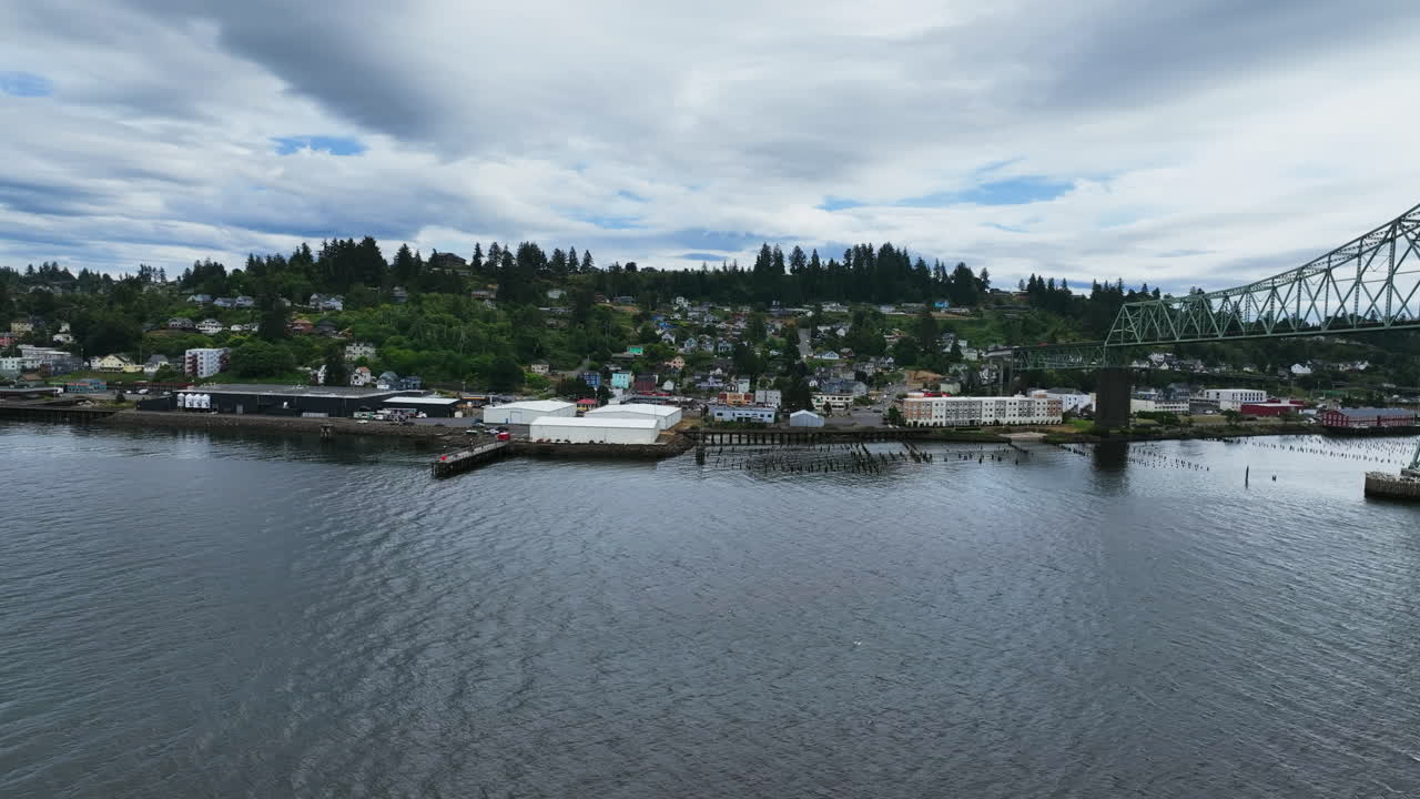 Aerial view over the river, toward the Astoria town, gloomy day in Oregon, USA