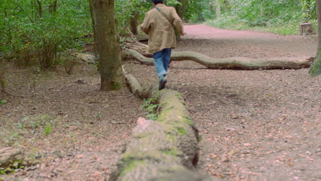 running over a horizontal tree in the forest