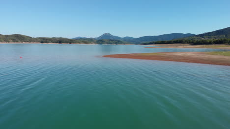 aerial view over lake plastiras shoreline on a hot day in greece