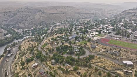 maupin oregon aerial v2 panoramic panning view drone flyover remote small town along the deschutes river capturing barren canyon landscape on a hazy day - shot with mavic 3 cine - august 2022