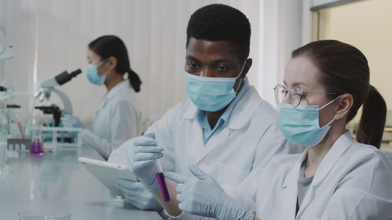 Multi-Ethnic Scientists Discussing Chemical Reaction