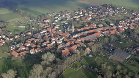 Drone-aerial-of-the-typical-german-village-Seeburg-located-at-the-Seeburger-See-on-a-beautiful-Sunday-morning