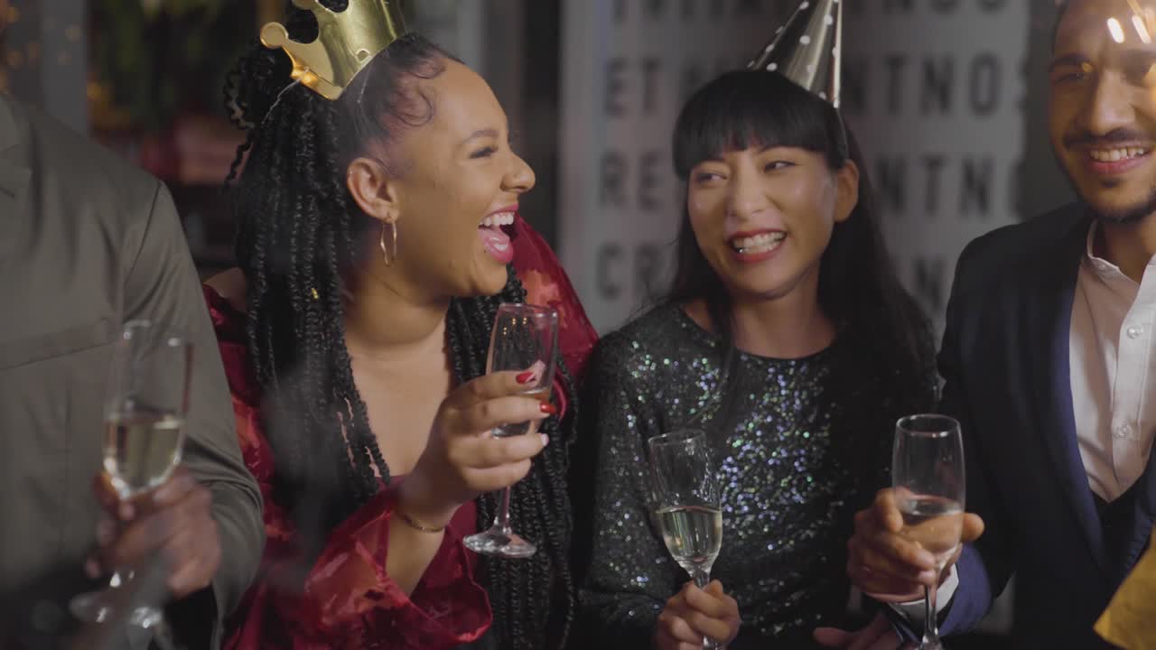 Tracking Shot Approaching Friends Celebrating New Years Eve with Champagne and Sparklers