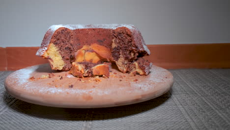 traditional marble cake on wooden plate, sliding dolly shot, close up