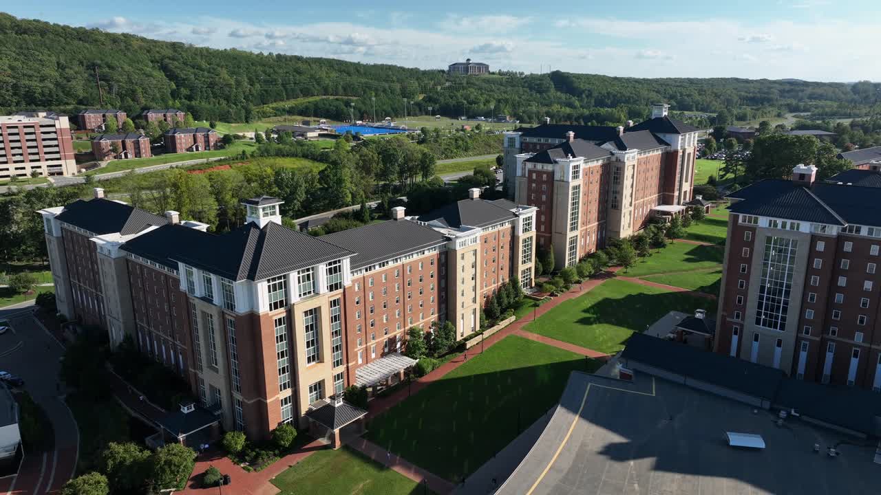 Luxury multi family units and apartments for student on private America. University. Sunny summer day with traffic on highway in Virginia, USA. drone wide shot