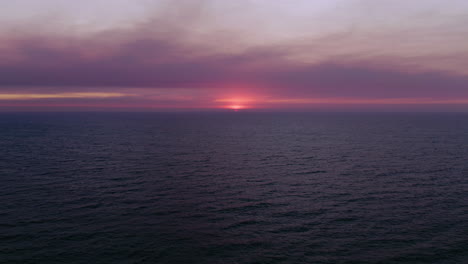 aerial drone of cloudy perth sunset from city beach over the indian ocean