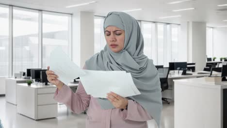 stressed muslim businesswoman reading reports