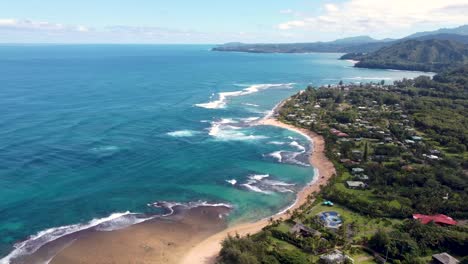 Aerial-view-of-waves-crashing-over-tropical-coral-reef-in-Kauai,-Hawaii,-USA