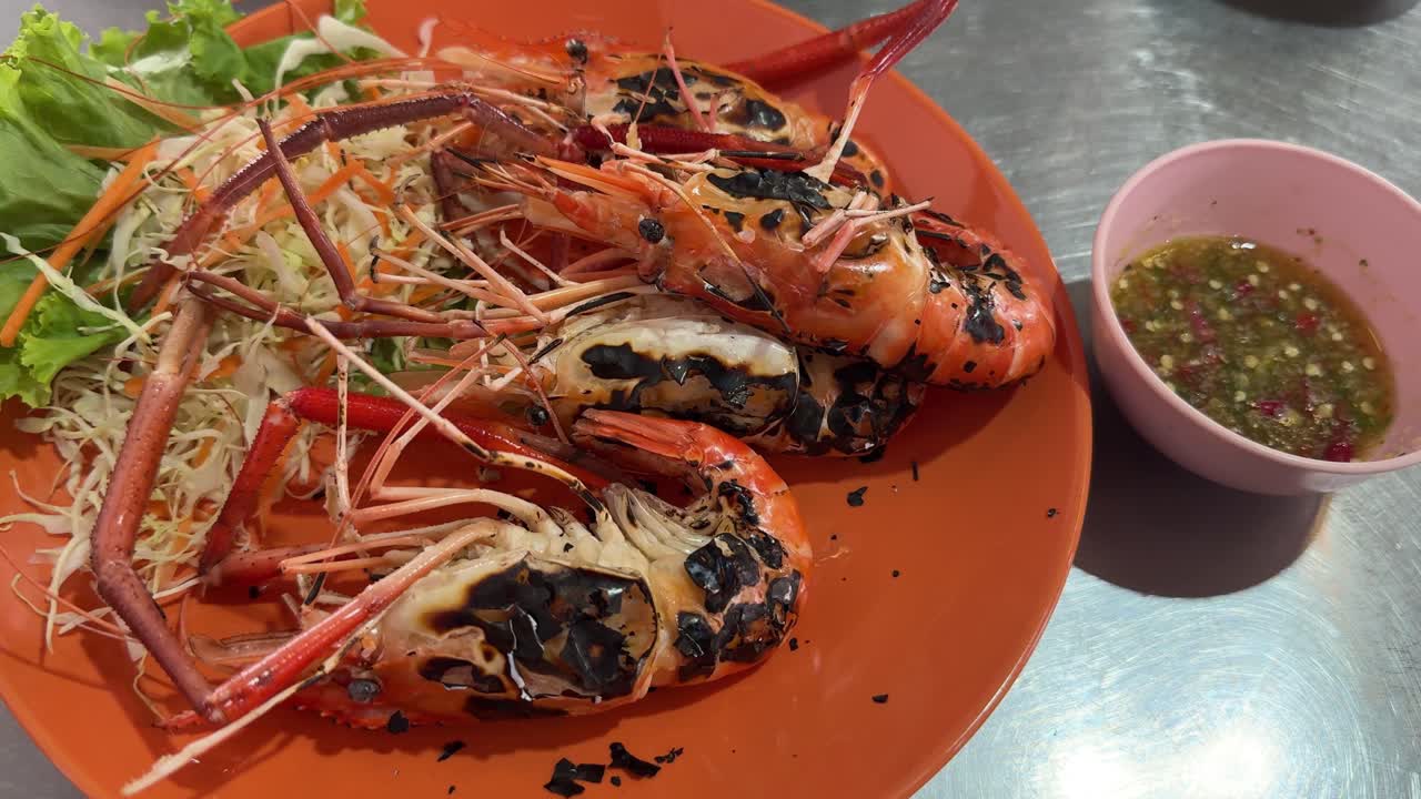 Seafood on grill, giant prawns Asian Style sauce and salad cooked on charcoal