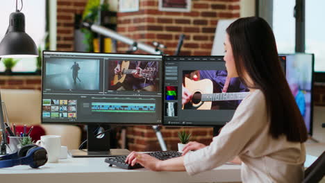 asian woman edits videos in a creative software at her home office