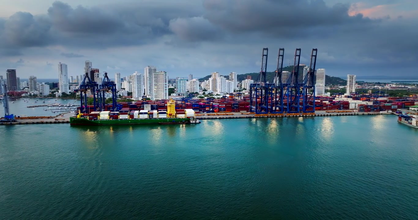 Docked container ship at Cartagena seaport with ship-to-shore cranes. Aerial