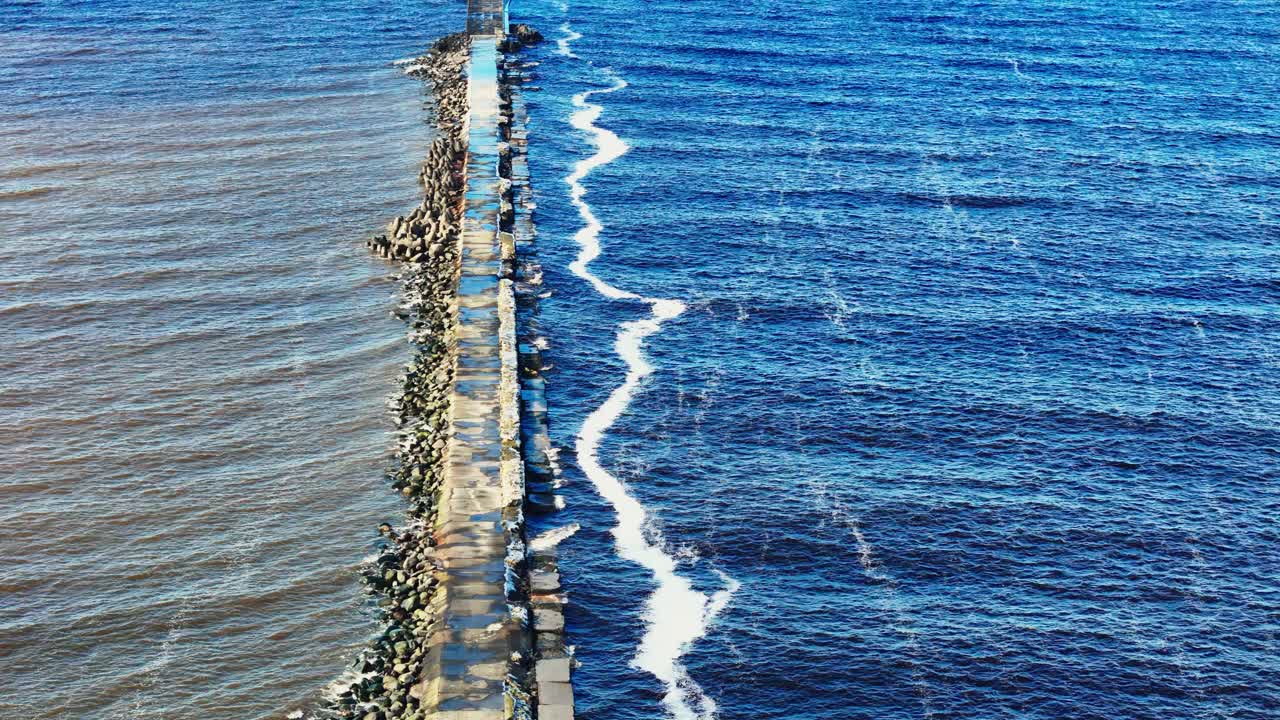 Drone footage of a coastal lighthouse at a river-sea confluence in Riga, Latvia