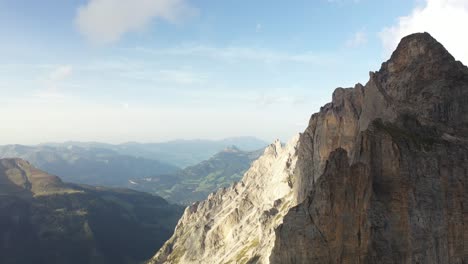 Slow-drone-shot-going-sideways-to-the-left,-revealing-the-sharp-and-steep-mountain-ridge-of-Dossengrat-in-Switzerland