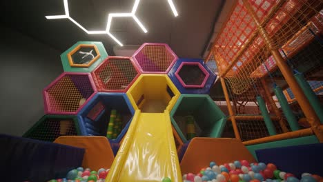 colorful indoor playground with slide and ball pit