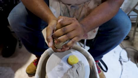 close up view of africans american black hands molding clay passionately and strongly