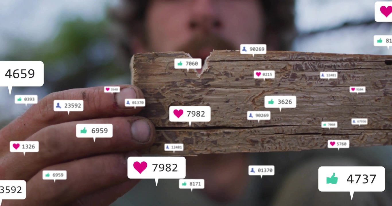 Man Holding Damaged Wood Piece with Floating Social Media Icons