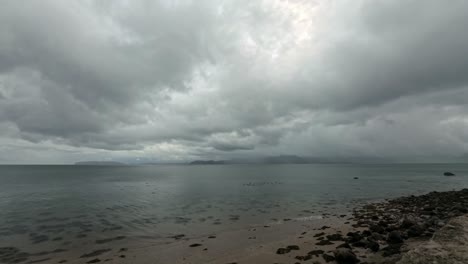 threatening timelapse storm clouds speeding across snowdonia mountain range and irish seascape