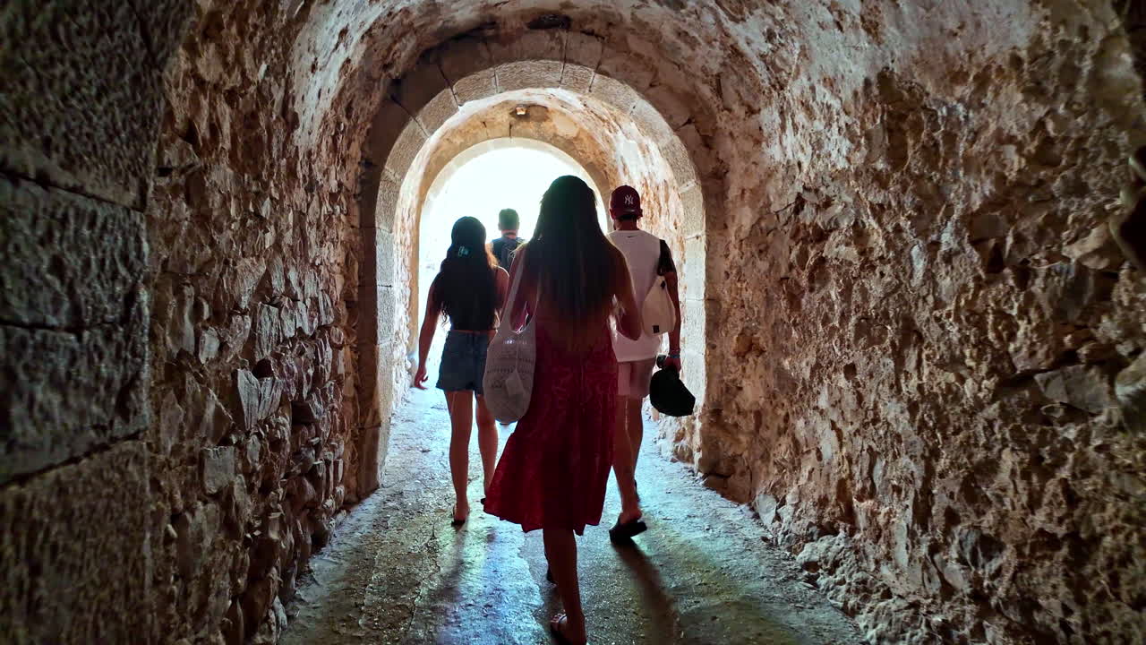 People walking through an old tunnel