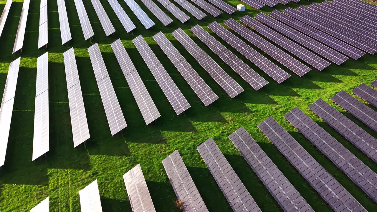 Solar panels spread across a green field capture sunlight efficiently
