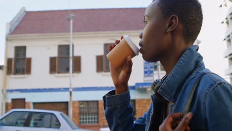 woman having coffee while walking in city street 4k