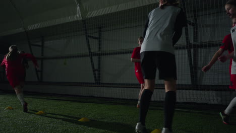 young female soccer players training indoors