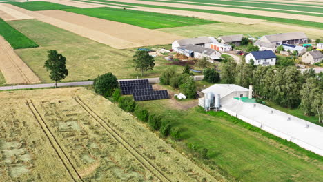 solar panels in the poultry farm in daytime. - aerial shot