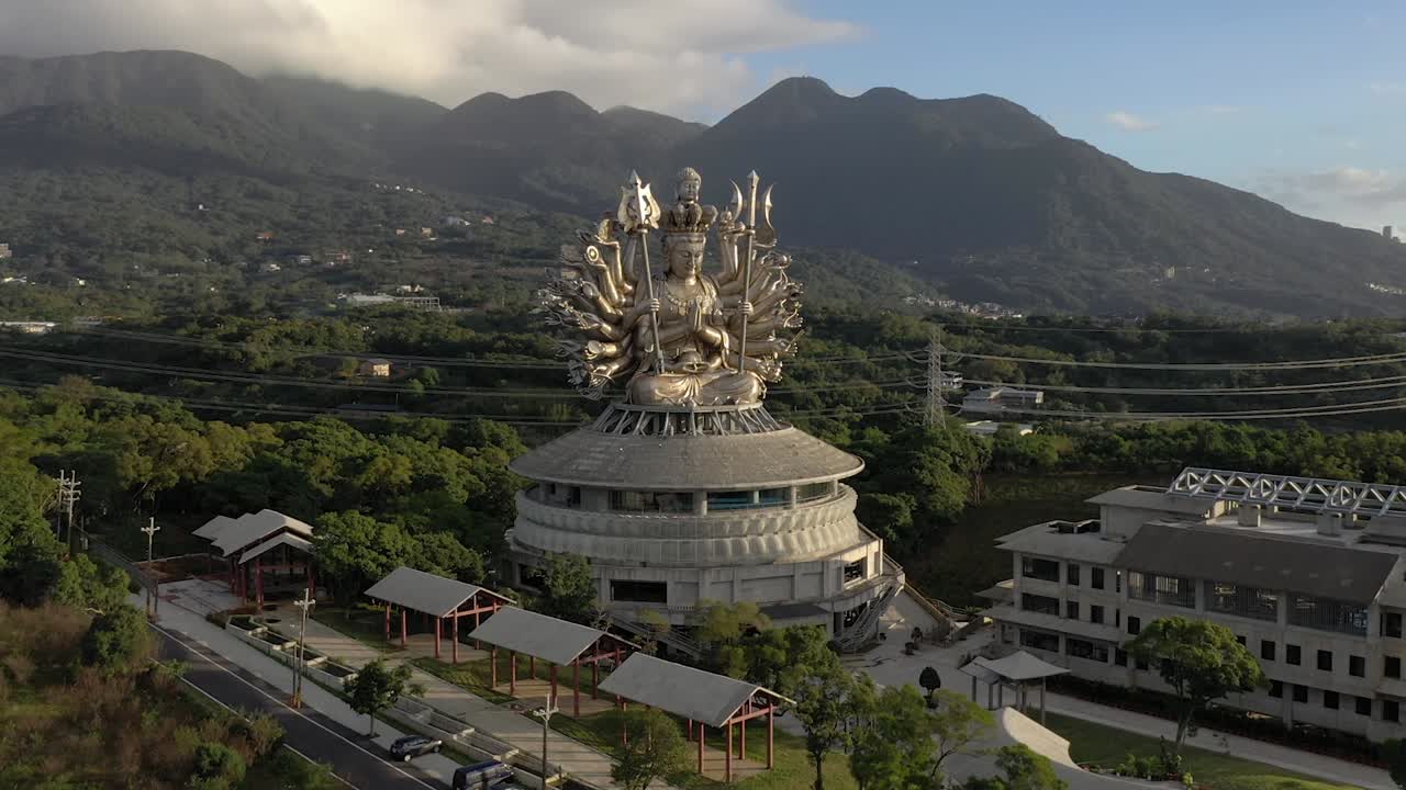 많은 팔과 두 개의 홀을 가진 중국의 거대한 관음 여신 은상
