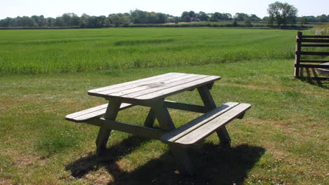 Picnic-bench-in-a-green-grass-field-on-a-farm