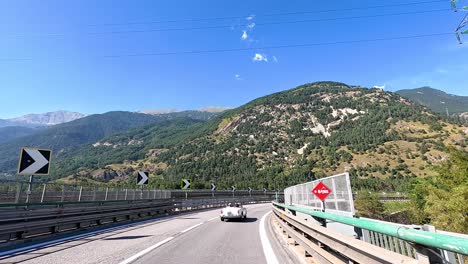 car driving on mountain road in piedmont, italy