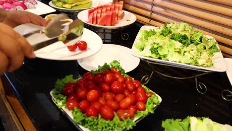 serving tomatoes at a breakfast buffet