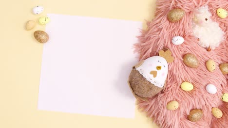 happy easter write on paper with easter arrangement on pastel yellow background, stop motion