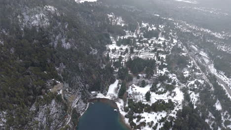 aerial view of forested mountains with scattered houses at lago perito moreno lake in winter landscape, colonia suiza, bariloche, argentina