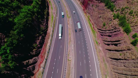 Beautiful-aerial-of-semi-truck-with-dry-van-trailer-between-hills-in-Maryland-USA