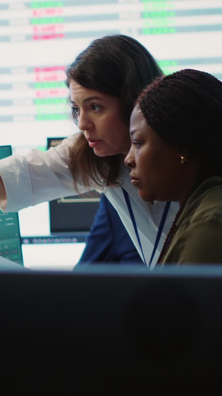 Two Businesswomen Collaborating on Stock Market Analysis in a Trading Office