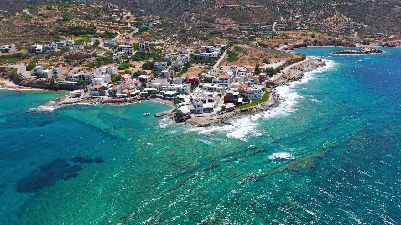 Whitewashed buildings of Mochlos village on the coast of the turquoise sea in Crete