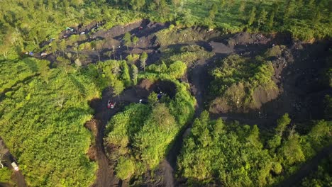 Drone-birds-eye-shot-of-worker-destroying-nature-and-wilderness-in-Asia---Sand-mine-activity,-cutting-wooden-trees-illegal-in-forest