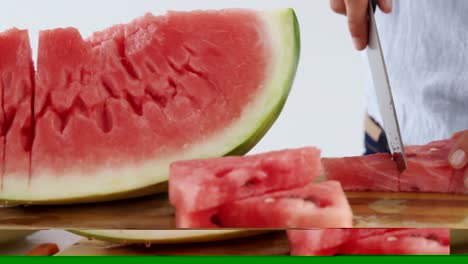 Mid-section-of-woman-cutting-fruits-on-chopping-board-against-white-background