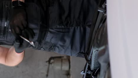 close-up of a mechanic working in a garage